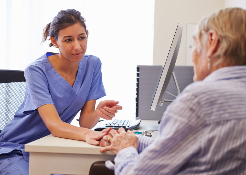 A physician consults with an older patient.