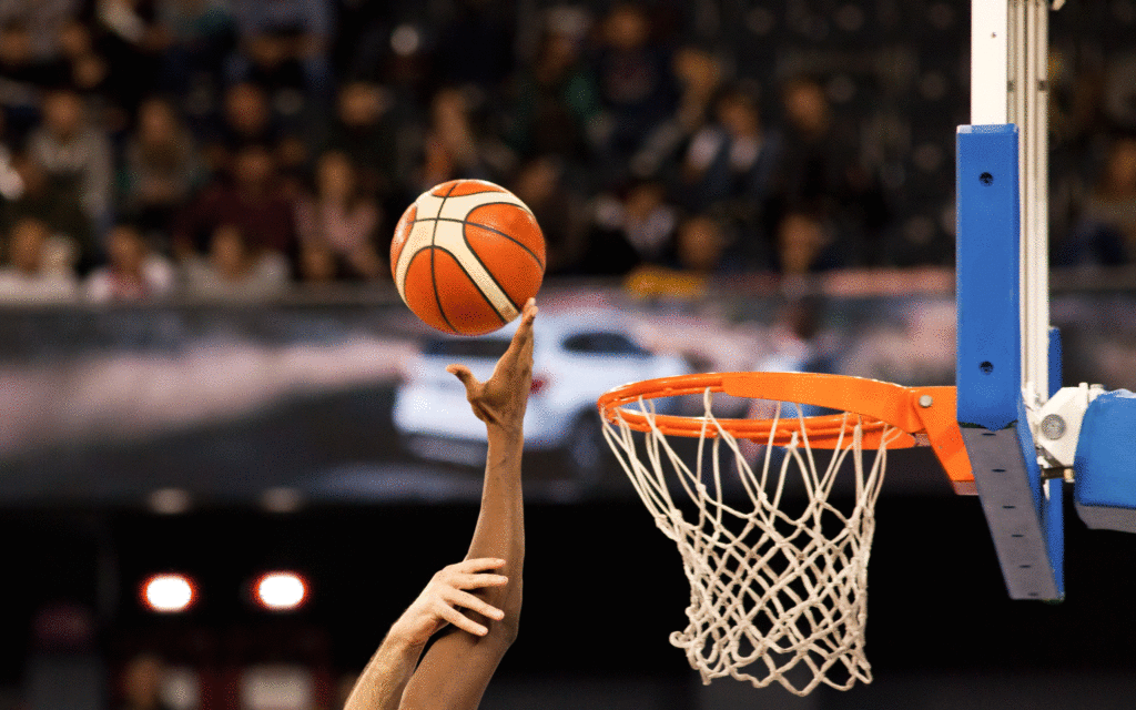 international student athlete throws basketball into hoop
